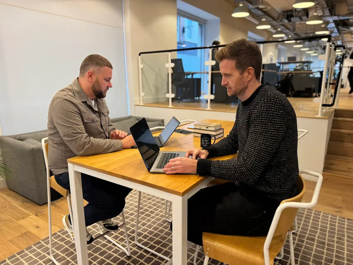 Rikki and Mark working through a migration plan at a desk