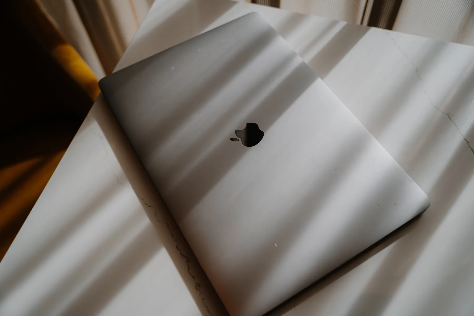 A closed laptop in the afternoon light