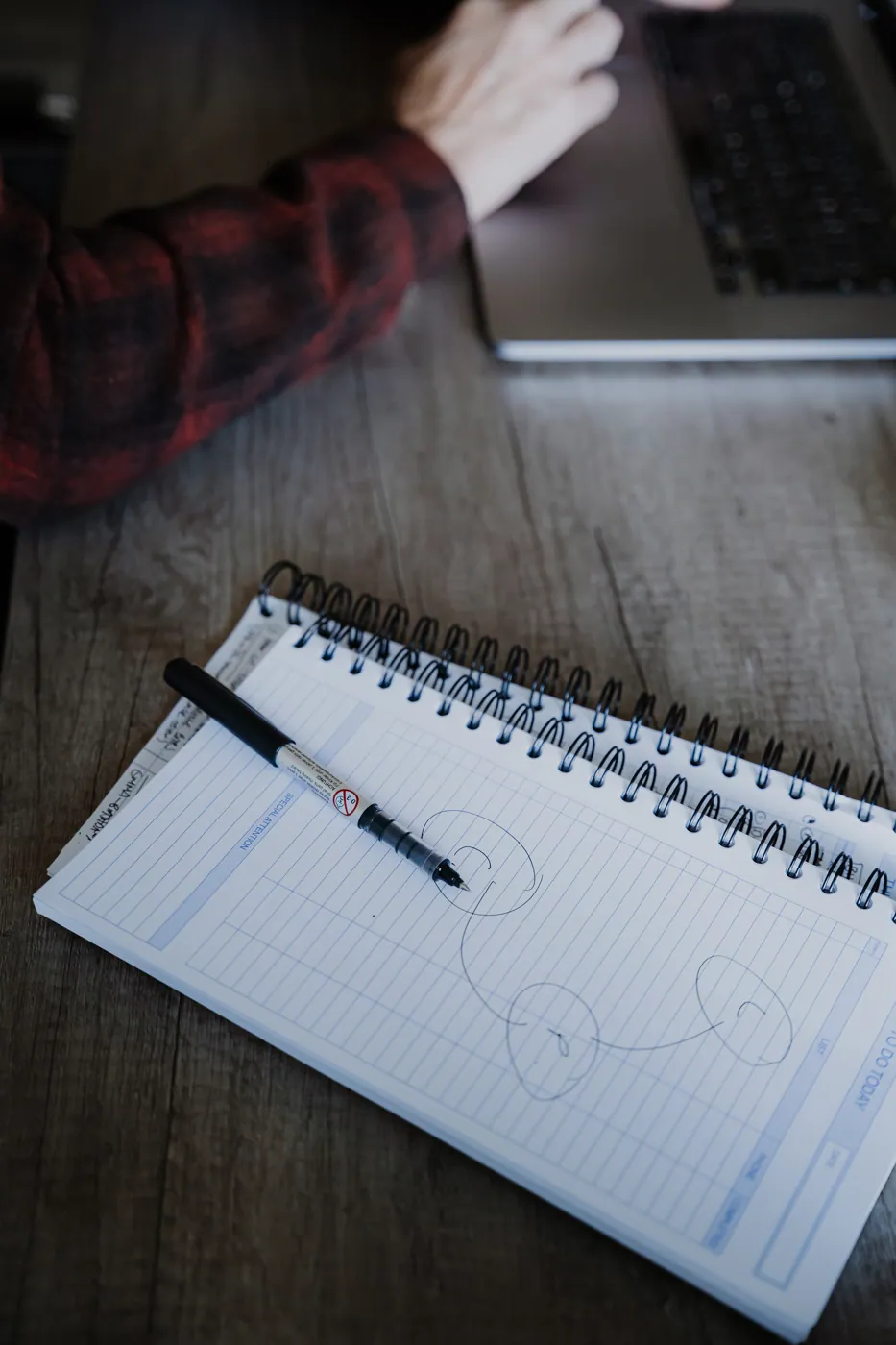 A notebook and pen on the meeting table