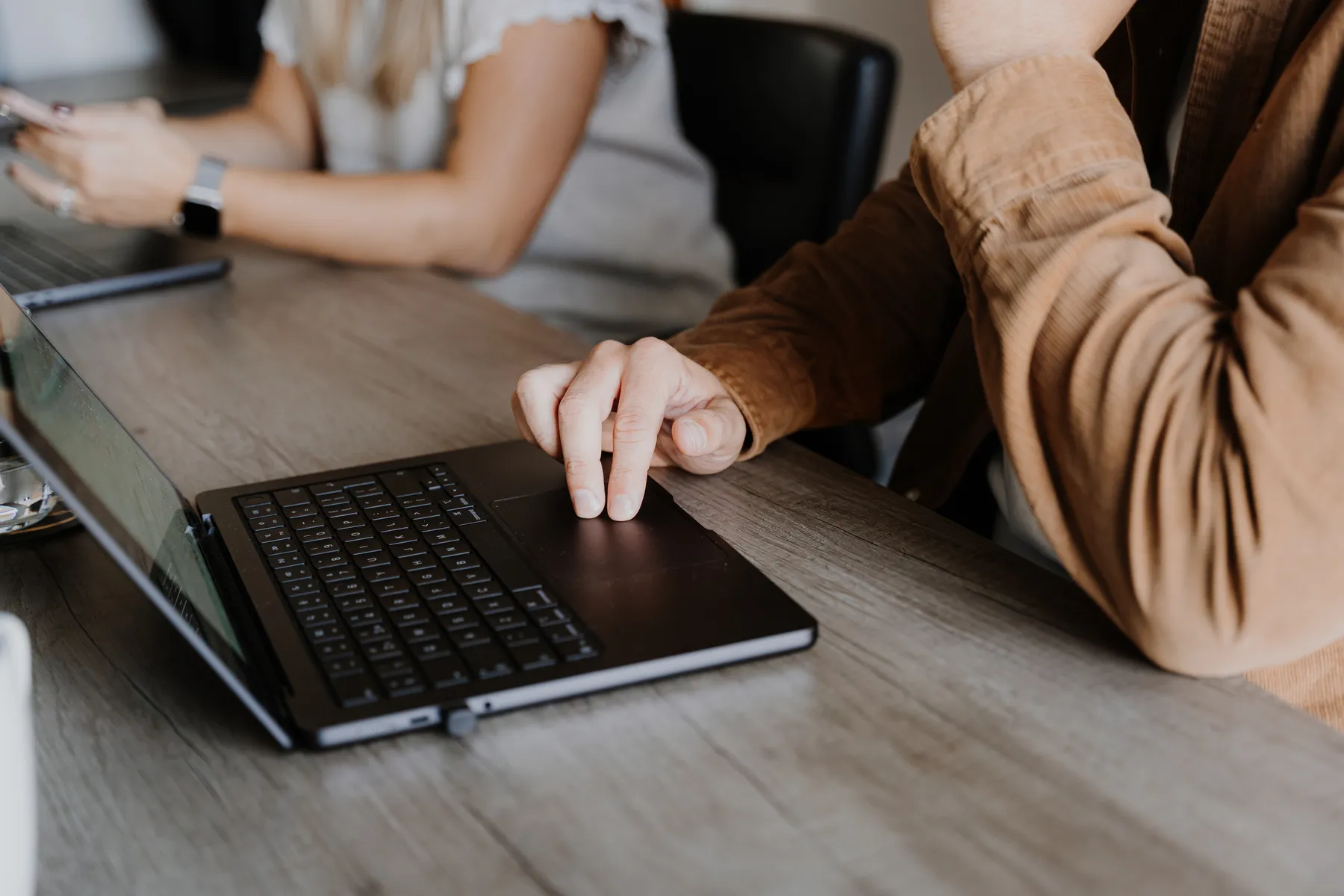 Hands on a laptop keyboard